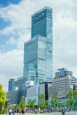 Tall building with people around.